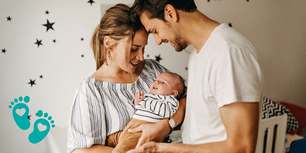 Happy parents holding their newborn baby, providing essential baby shoe resources for first-time parents with Grookz Shoes