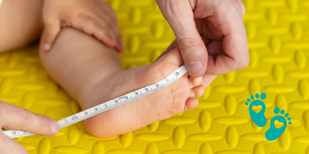 Measuring a baby's foot with a tape measure on a yellow mat, demonstrating Grookz Shoes' Free Baby Shoe Size Recommender Tool