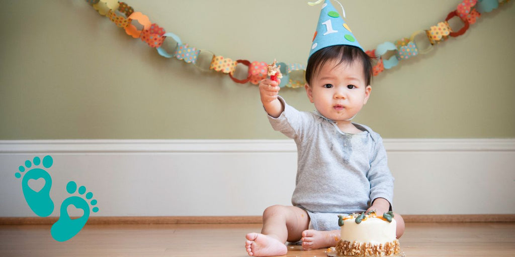 Baby wearing a party hat and sitting with a cupcake, decoding the world of 12-month-old baby shoes with Grookz Shoes