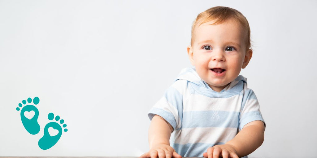 Smiling baby in a light blue striped shirt, exploring why babies hate shoes and providing insights into baby shoes and sock shoes with Grookz Shoes