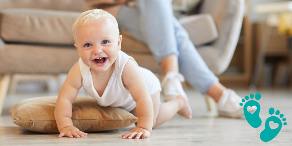 Happy baby crawling on the floor with a parent in the background, offering a behind-the-scenes look at the craftsmen behind Grookz Shoes